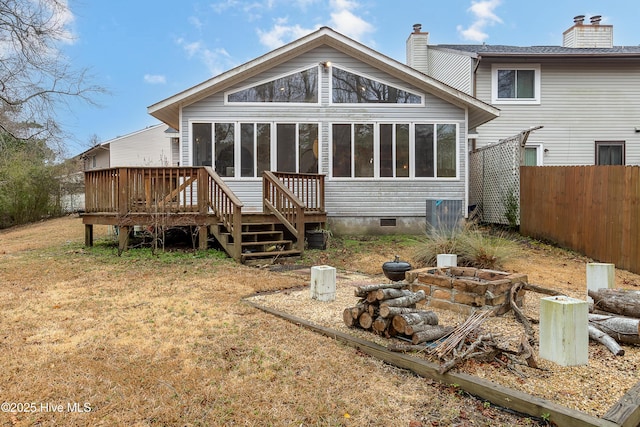 back of property with a wooden deck and an outdoor fire pit