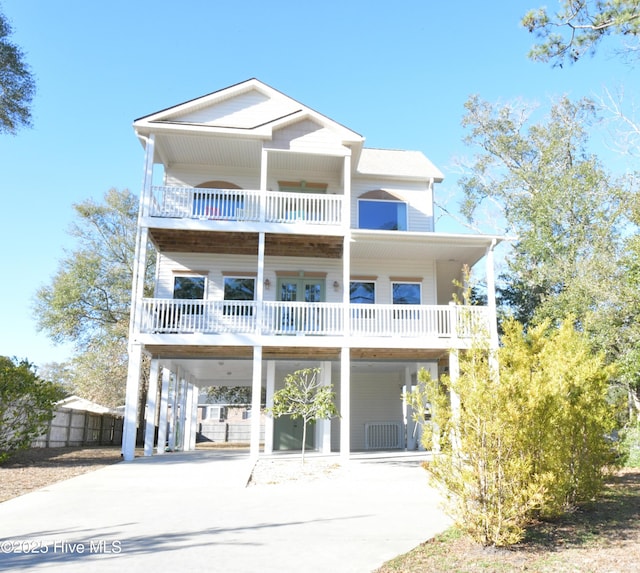 coastal home featuring a balcony and a carport