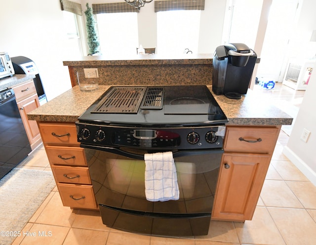 kitchen with black appliances and light tile patterned floors