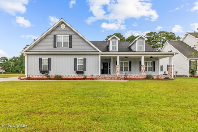 view of front of house with a front yard and covered porch