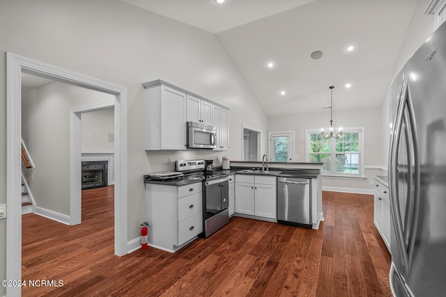 427 Candlewood Dr, Jacksonville, NC 28540 - kitchen featuring appliances with stainless steel finishes, white cabinetry, sink, hanging light fixtures, and kitchen peninsula