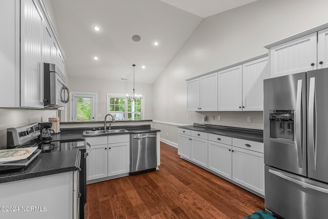 427 Candlewood Dr, Jacksonville, NC 28540 - kitchen featuring appliances with stainless steel finishes, dark hardwood / wood-style floors, pendant lighting, white cabinetry, and sink