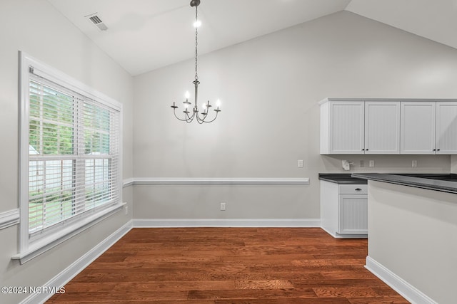 427 Candlewood Dr, Jacksonville, NC 28540 - kitchen with lofted ceiling, decorative light fixtures, a chandelier, dark hardwood / wood-style flooring, and white cabinets
