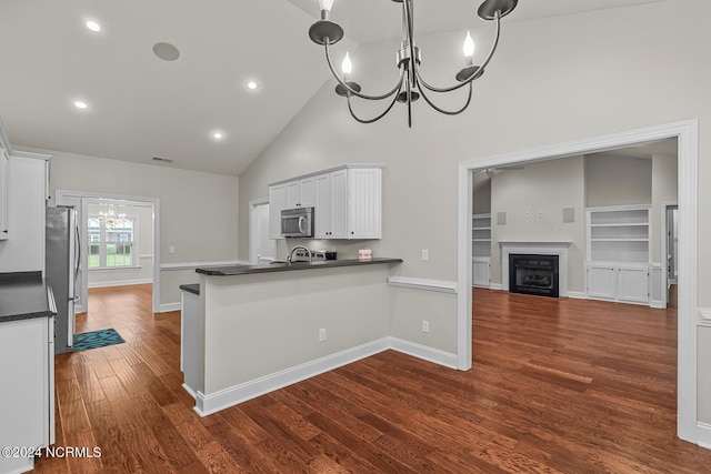 427 Candlewood Dr, Jacksonville, NC 28540 - kitchen with pendant lighting, appliances with stainless steel finishes, kitchen peninsula, and white cabinets