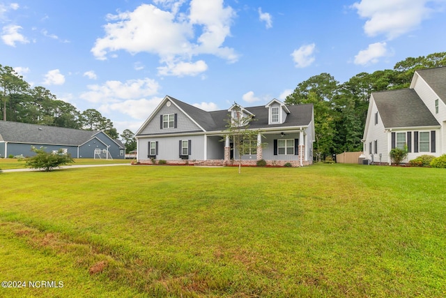 cape cod house with a front yard and a porch