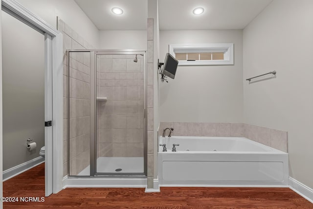427 Candlewood Dr, Jacksonville, NC 28540 - bathroom featuring hardwood / wood-style flooring, separate shower and tub, and toilet