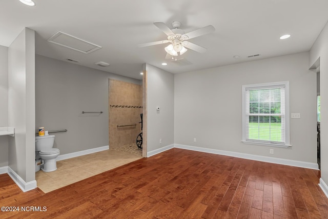 427 Candlewood Dr, Jacksonville, NC 28540 - bathroom with wood-type flooring, tiled shower, ceiling fan, and toilet