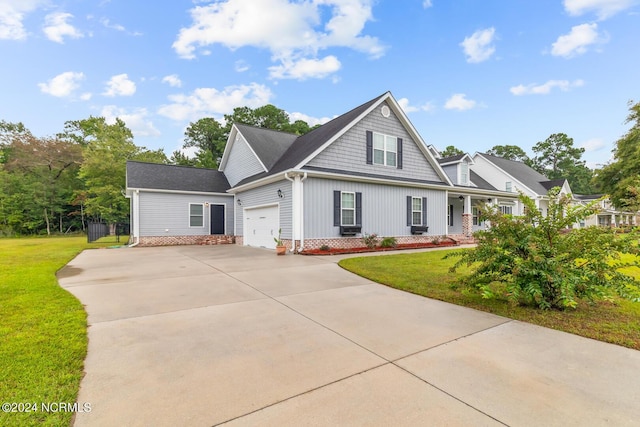 427 Candlewood Dr, Jacksonville, NC 28540 - view of front of house with a garage, a front lawn, and covered porch