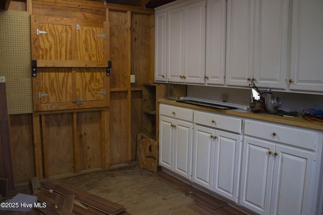 kitchen featuring white cabinetry and hardwood / wood-style flooring