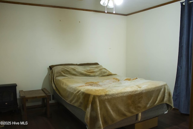 bedroom with crown molding and dark hardwood / wood-style floors