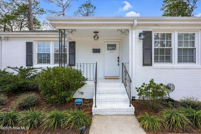 property entrance featuring brick siding