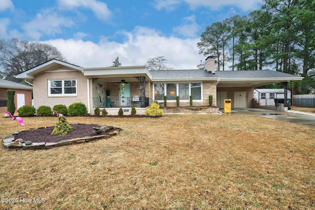 ranch-style home featuring a carport, a porch, a front yard, and ceiling fan