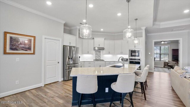 dining area featuring a tray ceiling and ornamental molding