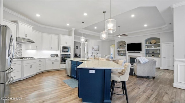 4358 Cobleskill Dr, Leland, NC 28451 - kitchen featuring stainless steel appliances, a sink, a ceiling fan, under cabinet range hood, and white cabinets
