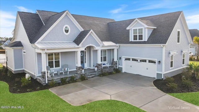 4358 Cobleskill Dr, Leland, NC 28451 - view of front of property featuring a porch, a standing seam roof, a garage, driveway, and metal roof