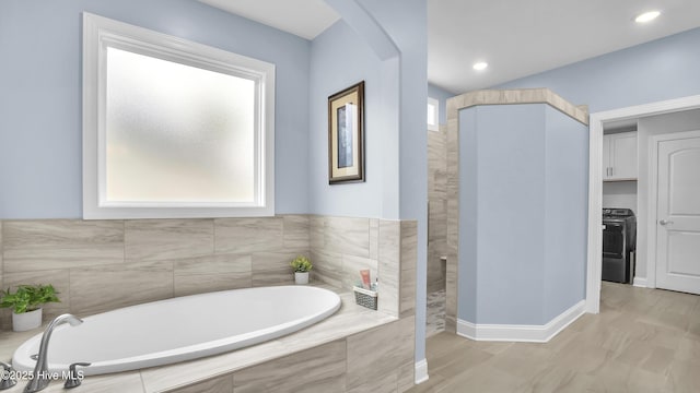 bathroom featuring a garden tub, recessed lighting, a walk in shower, and baseboards