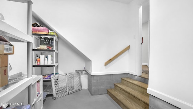 staircase with finished concrete floors