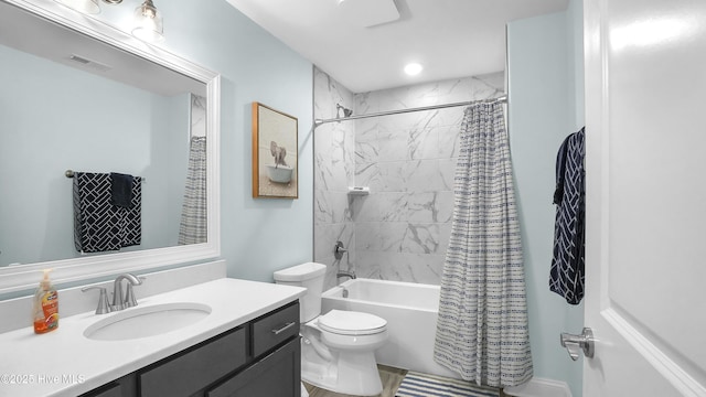 full bath with visible vents, vanity, toilet, and shower / tub combo