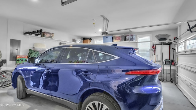 garage with electric panel and a garage door opener