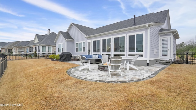 rear view of property featuring an outdoor living space with a fire pit, a patio area, a lawn, and a fenced backyard