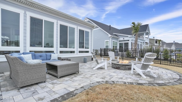 view of patio featuring an outdoor living space with a fire pit and fence