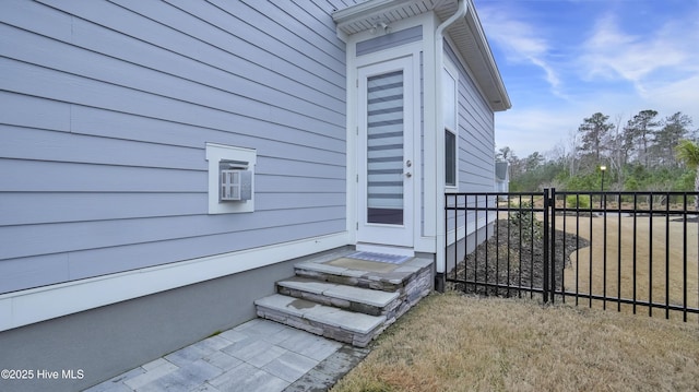 view of exterior entry featuring fence