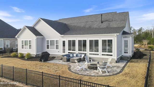 back of house featuring an outdoor living space with a fire pit, a patio area, and a fenced backyard