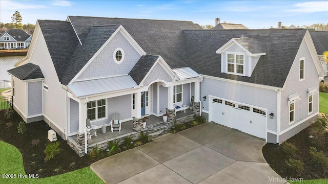 4358 Cobleskill Dr, Leland, NC 28451 - view of front of home with covered porch, a standing seam roof, concrete driveway, metal roof, and an attached garage