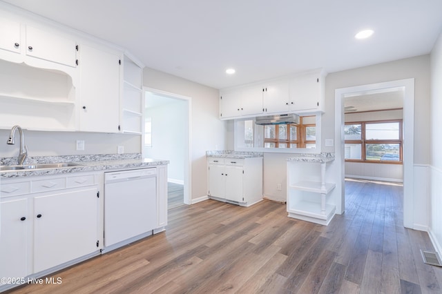 kitchen with dark hardwood / wood-style flooring, dishwasher, sink, and white cabinets