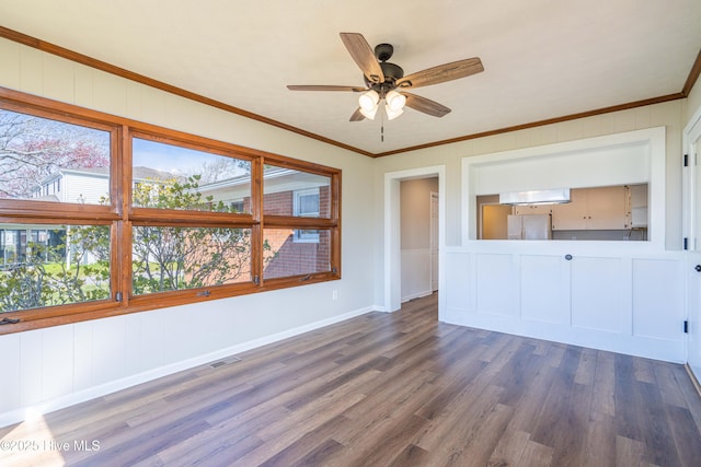 empty room with crown molding, ceiling fan, and dark hardwood / wood-style flooring