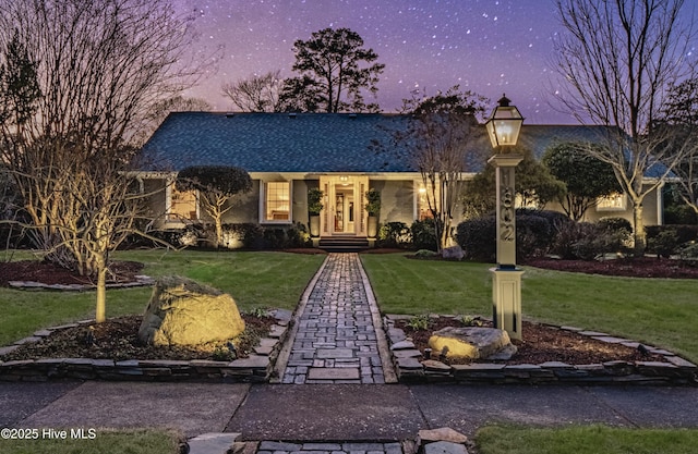 view of front of property with a yard