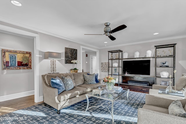 living room with baseboards, ceiling fan, wood finished floors, crown molding, and recessed lighting