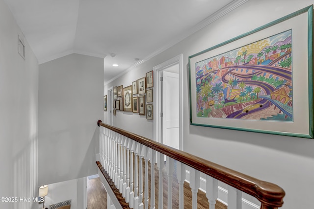 corridor with wood finished floors, an upstairs landing, baseboards, vaulted ceiling, and crown molding