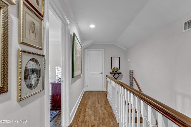 hallway with lofted ceiling, recessed lighting, an upstairs landing, light wood-type flooring, and baseboards