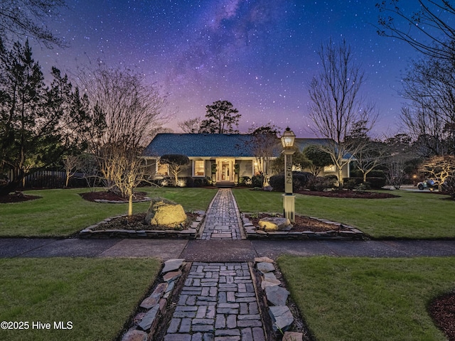 back of property featuring a lawn