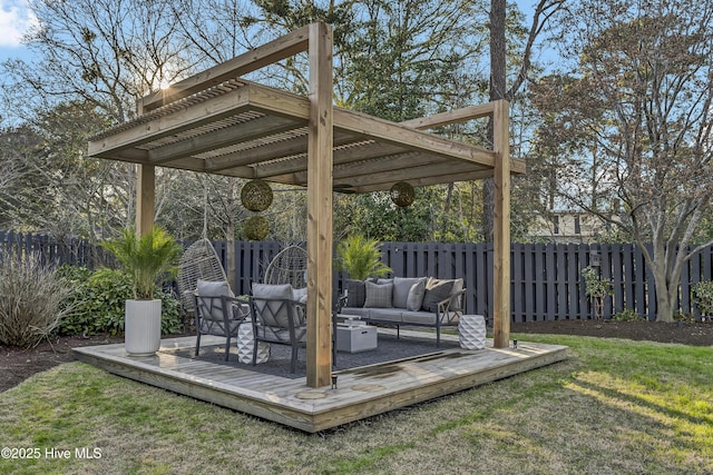 exterior space featuring a wooden deck, fence, an outdoor living space, and a pergola