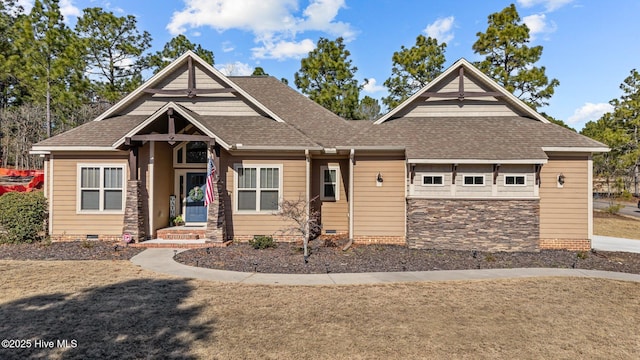 craftsman-style home featuring crawl space, stone siding, and a shingled roof