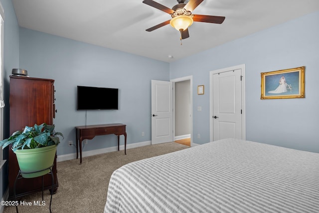 bedroom with baseboards, a ceiling fan, and light colored carpet