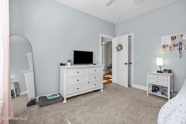 bedroom with light carpet, ceiling fan, arched walkways, and baseboards