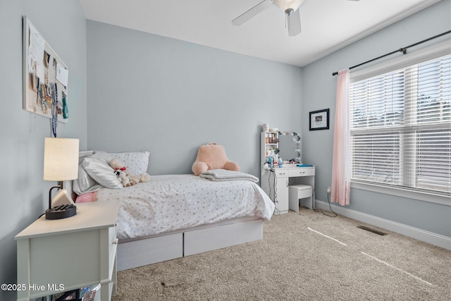 bedroom featuring light carpet, visible vents, a ceiling fan, and baseboards