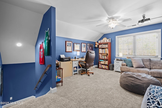 office space with carpet, lofted ceiling, visible vents, a ceiling fan, and baseboards