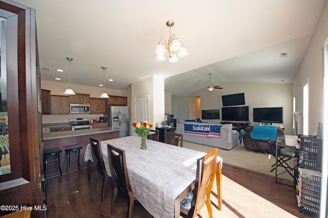 dining room featuring lofted ceiling, dark wood-type flooring, and ceiling fan with notable chandelier