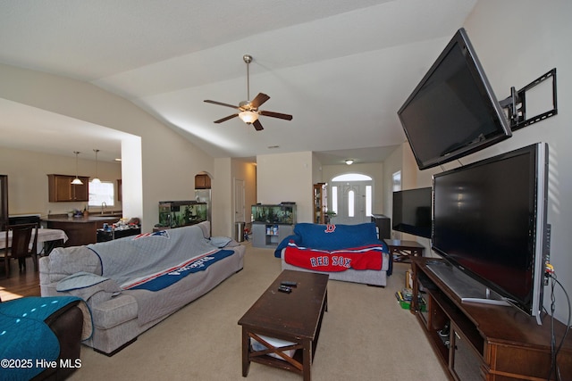 living room with lofted ceiling, light colored carpet, and ceiling fan