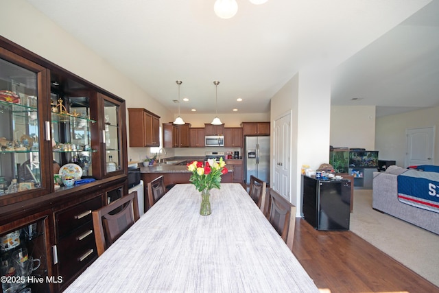 dining space featuring dark hardwood / wood-style flooring and sink