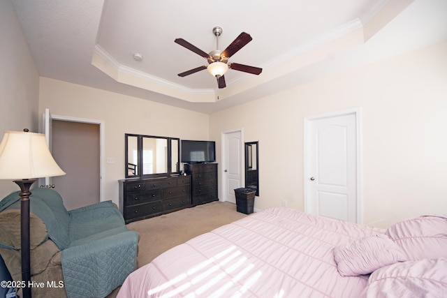 bedroom with ceiling fan, light colored carpet, ornamental molding, and a raised ceiling