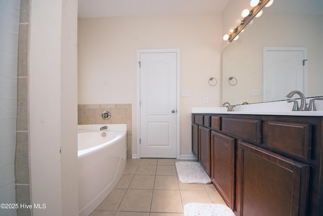 bathroom featuring vanity, a tub to relax in, and tile patterned floors