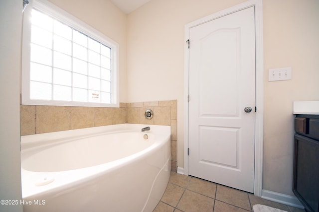 bathroom with vanity, tile patterned floors, and a tub to relax in