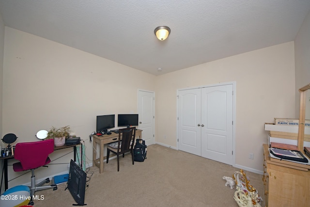 office area featuring light colored carpet and a textured ceiling