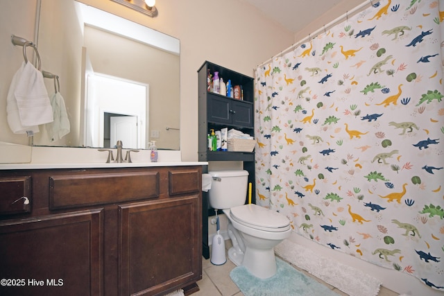 bathroom featuring vanity, toilet, curtained shower, and tile patterned flooring