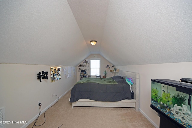 carpeted bedroom with lofted ceiling and a textured ceiling